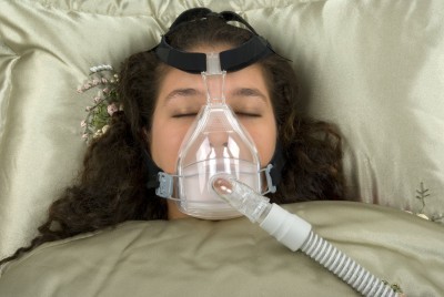 Woman Using a CPAP Machine